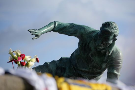Flowers and tributes adorn the statue of Sir Tom Finney at Deepdale Stadium 