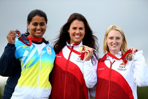 The medalists (L-R) Shreyasi Singh of India (Silver) Charlotte Kerwood of England (Gold) and Rachel Parish of England (Bronze) celebrate on the podium after the Women's Double Trap final at Barry Buddon Shooting Centre 