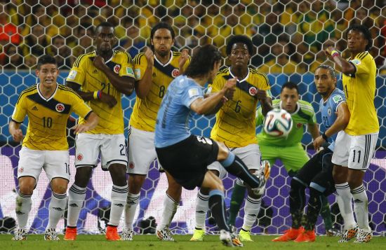 Uruguay's Edinson Cavani takes a free kick but fails to score a goal against Colombia