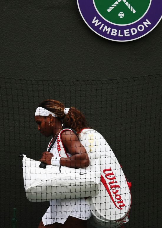 Serena Williams of the United States walks of dejected after losing her Ladies' Singles third round match to Alize Cornet of France