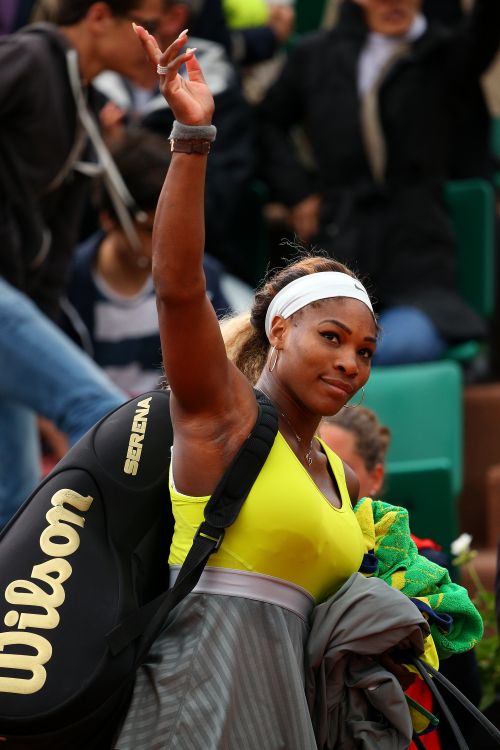 Serena Williams of the United States waves to the crowd as she leaves the court following her defeat in the women's singles match against Garbine Muguruza of Spain