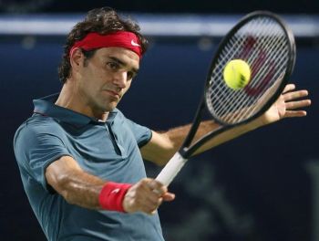 Roger Federer returns the ball to Novak Djokovic during their men's singles semi-final match