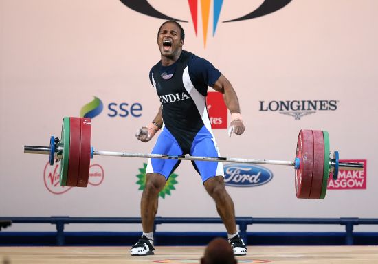 Sathish Sivalingam of India celebrates during the Men's Weightlifting 77kg category at Scottish Exhibition And Conference Centre 