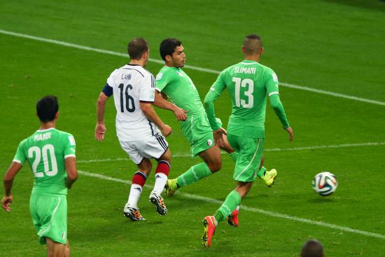 Abdelmoumene Djabou of Algeria shoots and scores his team's first goal in extra time 
