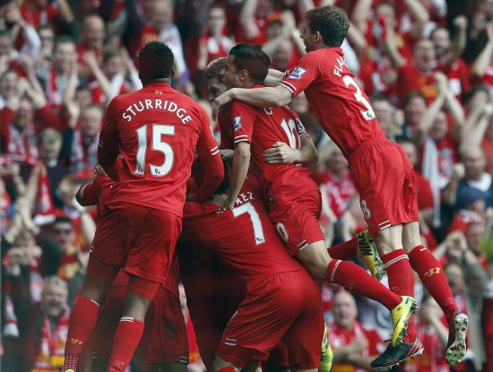 Liverpool players celebrate after scoring a goal