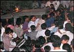 A Rediff phalanx, accompanied by policemen, guide Sachin through the crowd