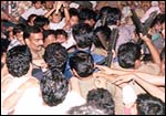 A Rediff phalanx, accompanied by policemen, guide Sachin through the crowd