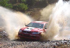 Armin Kremer (co-driver Fred Berssen) of Team MRF Tyres splash through a stream during the Leg 2 of the MRF India Rally.
