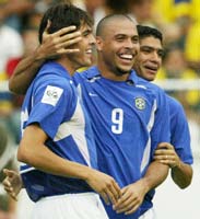 Brazil's Kaka (L) celebrates with Ronaldo (C) and Renato after scoring against Colombia.
