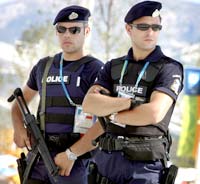 Armed Greek police officers stand guard outside the Olympic Stadium.