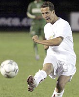 Ferrari Formula One driver Michael Schumacher, takes a free kick during the second half of a soccer match to benefit needy children in Palmeiras Stadium in Sao Paulo, October 20, 2004.