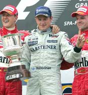 Kimi Raikkonen (centre), Michael Schumacher (left) and Rubens Barichello celebrate on the podium