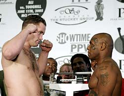 Mike Tyson (right) and Kevin McBride look at each other after weighing in for their upcoming fight