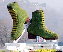 A pair of giant mossy figure skates stand outside the skating venue in Turin, Italy
