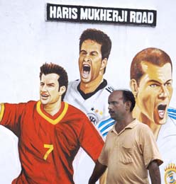 Paintings of football players on a wall in Kolkata