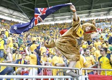 A fan waves the Australian flag before the start of Australia vs Japan match.