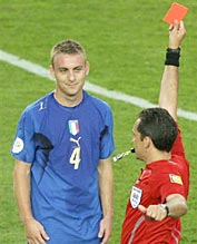 Referee Jorge Larrionda of Uruguay shows a red card to Italy's Daniele De Rossi.