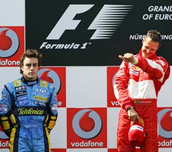 Michael Schumacher (right) celebrates as Fernando Alonso looks on dejectedly at the podium after the European Grand Prix