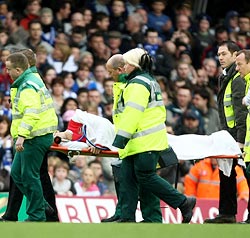 Eduardo da Silva is rushed to a hospital after injuring his left leg