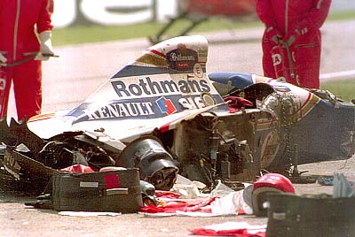 The Rothmans Williams car of Senna lies shattered on the track after he crashed into the concrete barrier during the early stages of the San Marino GP at Imola. Senna sustained serious head injuries in the accident and hospital staff pronounced him clinically dead
