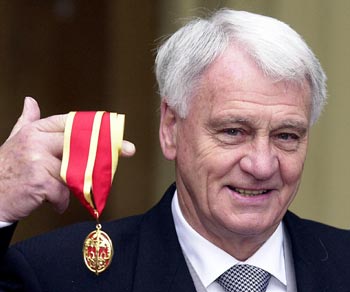 Newcastle manager Bobby Robson is seen posing with his award after receiving a Knighthood at Buckingham Palace in this November 11, 2002 file photograph.