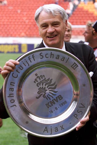 PSV Eindhoven's coach Bobby Robson holds up the trophy after winning the Dutch Super Cup [against Ajax] in Amsterdam.