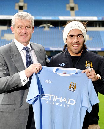 Manchester City striker Carlos Tevez (right) with manager Mark Hughes