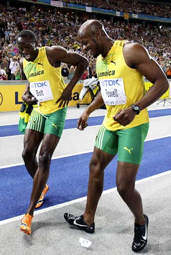 Usain Bolt (left) celebrates the victory with compatriot Asafa Powell