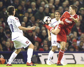 Liverpool skipper Steven Gerrard (right) gets innovative as he vies for possession with Fiorentina's Riccardo Montolivo