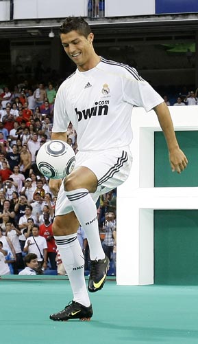 Cristiano Ronaldo plays with a ball during the presentation ceremony