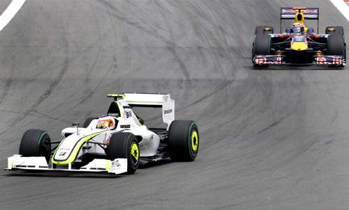 Image: Rubens Barrichello (left) drives in front of Red Bull's Mark Webber