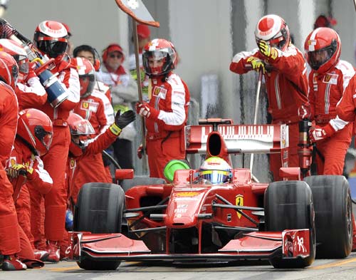 Felipe Massa receives a new set of tyres during a pit stop