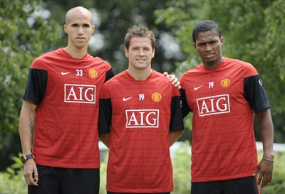 (from left to right) Manchester United's new signings Gabriel Obertan, Michael Owen and Antonio Valencia pose for photographs at the clubs Carrington training centre in Manchester