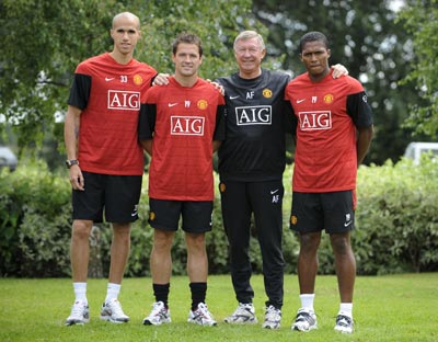 Manchester United's new signings Gabriel Obertan (left), Michael Owen and Antonio Valencia (right) pose for photographs with coach Alex Ferguson at the clubs Carrington training centre in Manchester
