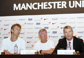 Manchester United's Chief Executive David Gill (right) speaks as manager Alex Ferguson (centre) and goalkeeper Edwin Van der Sar listen during a news conference at a hotel in Seoul on Thursday.