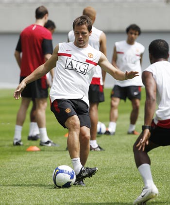 Manchester United's Michael Owen dribbles the ball during a training session at Seoul.