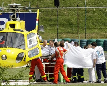 Medical staff lift Felipe Massa into a helicopter