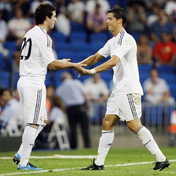 Real Madrid's Cristiano Ronaldo shakes hands with Higuain as he leaves the pitch during their Peace Cup match in Madrid