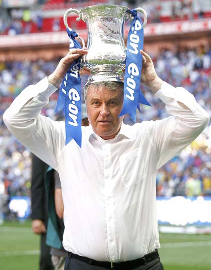 Chelsea's manager Guus Hiddink holds the trophy after their English FA Cup final win on May 30, 2009