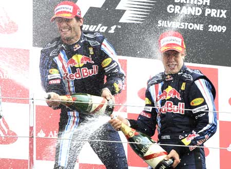Red Bull driver Sebastian Vettel (right) celebrates winning the British Grand Prix with teammate Mark Webber