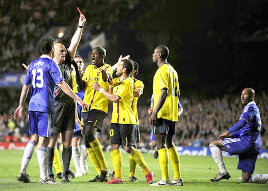 Barcelona's Eric Abidal (2nd from right) is shown the red card by referee Tom Henning Ovrebo after a challenge on Chelsea's Nicolas Anelka (right)