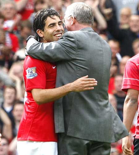 Carlos Tevez (left) celebrates with manager Alex Ferguson