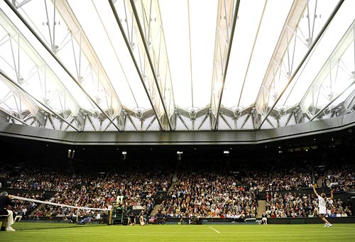 Steffi Graf serves against Kim Clijsters during their singles match