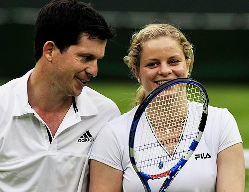 Kim Clijsters smiles with partner Tim Henman during the mixed doubles match
