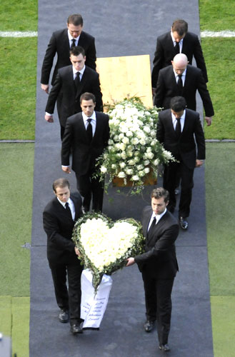 Pall bearers carry the coffin of late goalkeeper Robert Enke during a memorial service on Sunday
