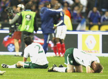 Ireland's St Leger and Damien Duff react after their loss to France