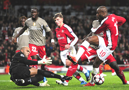 Standard Liege 'keeper Sinan Bolat saves a shot from Arsenal's William Gallas (10) in London on Tuesday