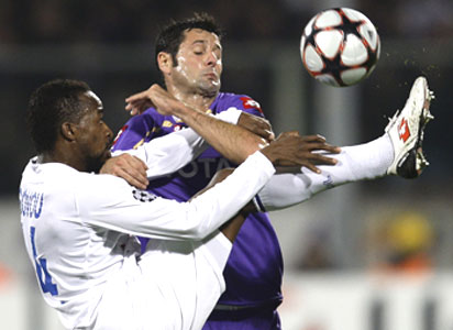 Fiorentina's Gobbi and Olympique Lyon's Govou (left) get entagled as they vie for possession during their Champions League match on Tuesday