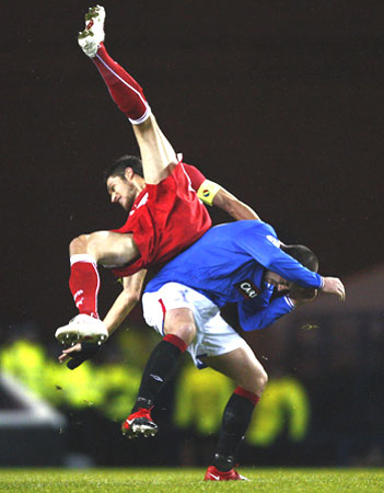 VfB Stuttgart's Delpierre falls over Rangers' Boyd during their Champions League match in Glasgow on Tuesday
