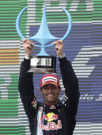 Mark Webber celebrates after a podium finish at the Brazilian GP